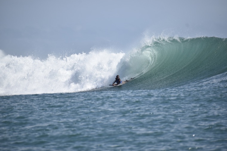 Anne-Cécile Lacoste bodyboarding on a powerful wave.
