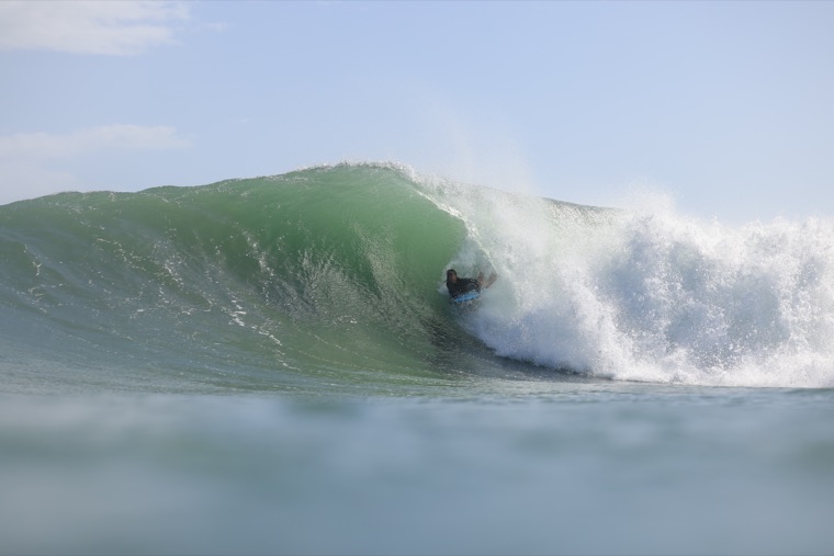 Anne-Cécile inside a bodyboard barrel.