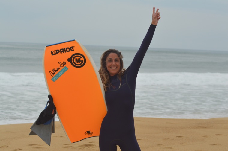 Anne-Cécile with an orange bodyboard.