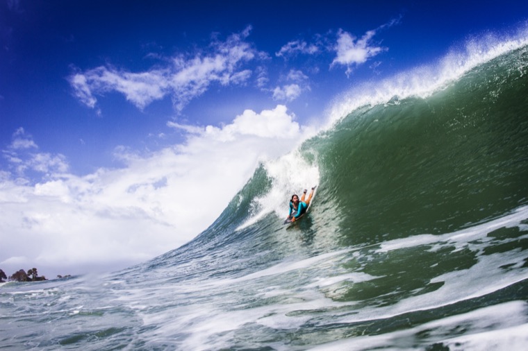 Anne-Cécile on a large blue wave.