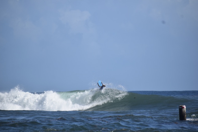 Anne-Cécile at the top of a wave.