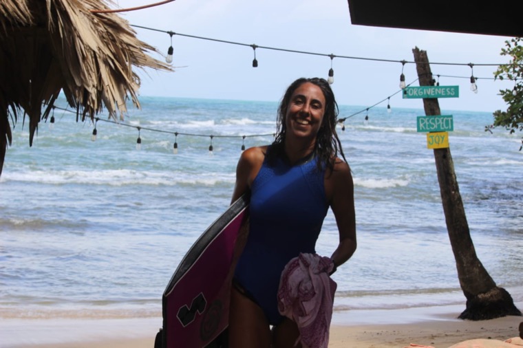Anne-Cécile happy with her bodyboard on the beach.